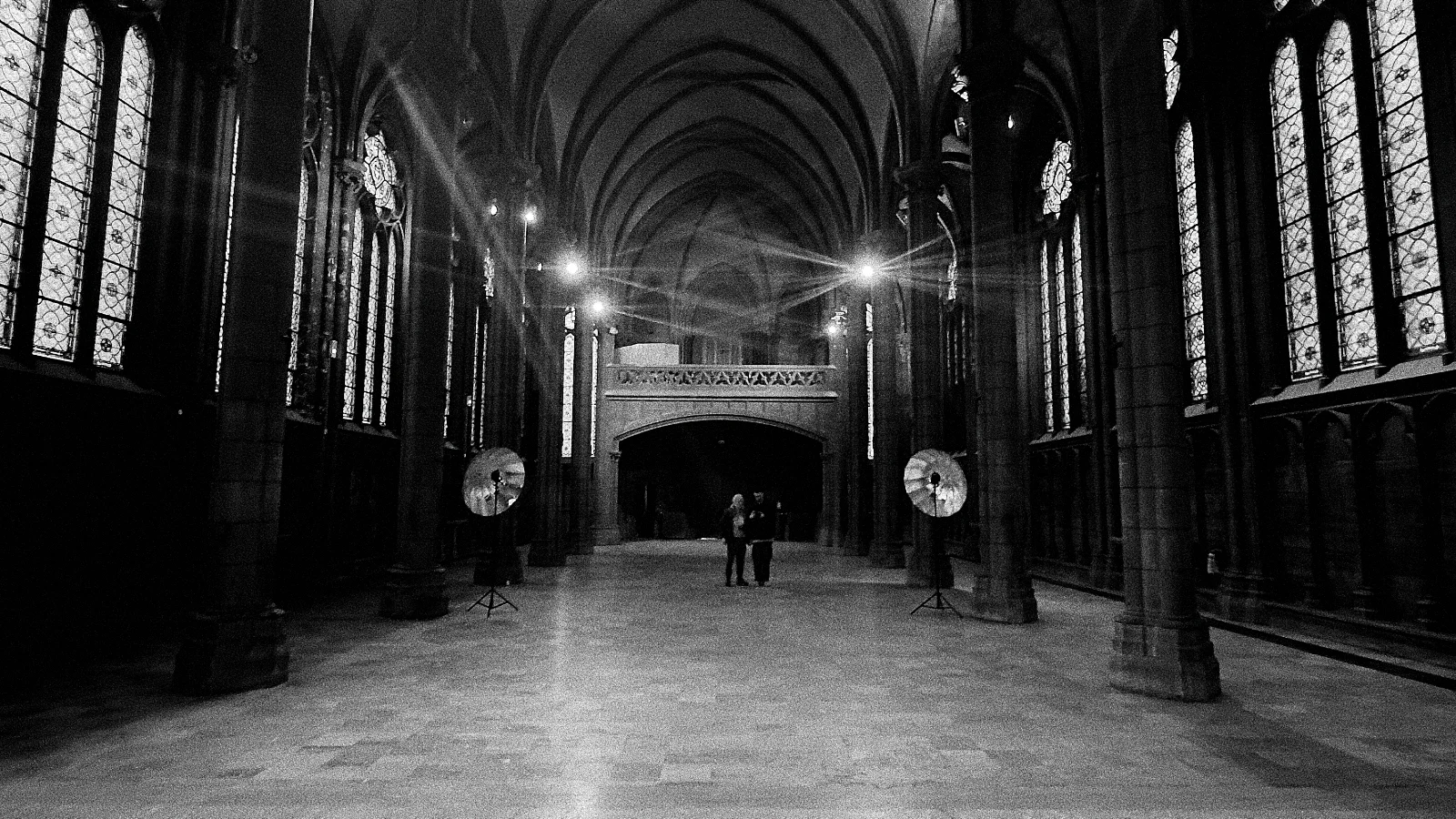 Black-and-white location scouting inside a Gothic hall
